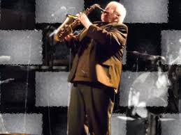 Brian Powers playing saxophone live on stage