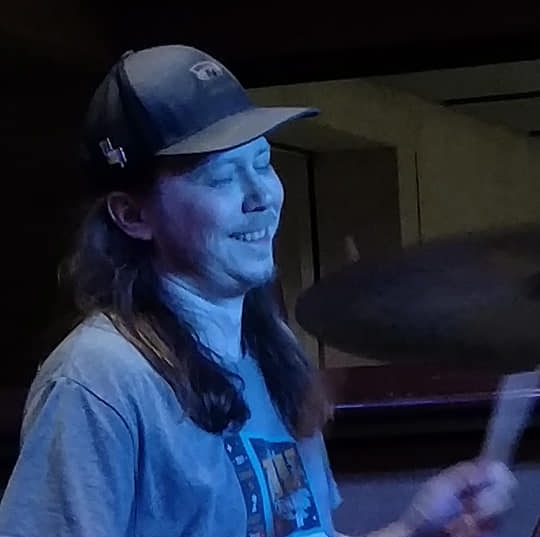 Derek Fagerwold playing drums on stage